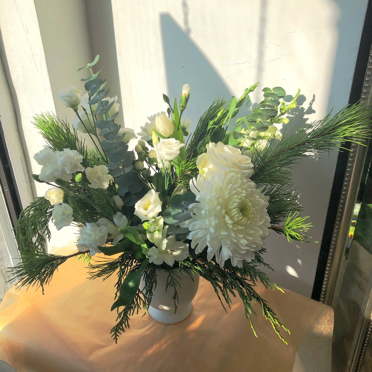 holiday christmas flower arrangement, white flowers, eucalyptus and evergreen branches, toronto flower delivery